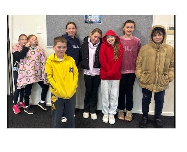 Stage 3 student posing in front of a wall